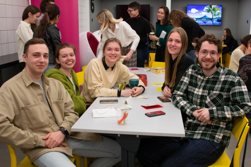 Elizaveta Shevchenko (second left), Vadim Galimov (right), and fellow staff of ITMO's Internationalization Office attend a board game night for students and staff. Credit: Megabyte Media
