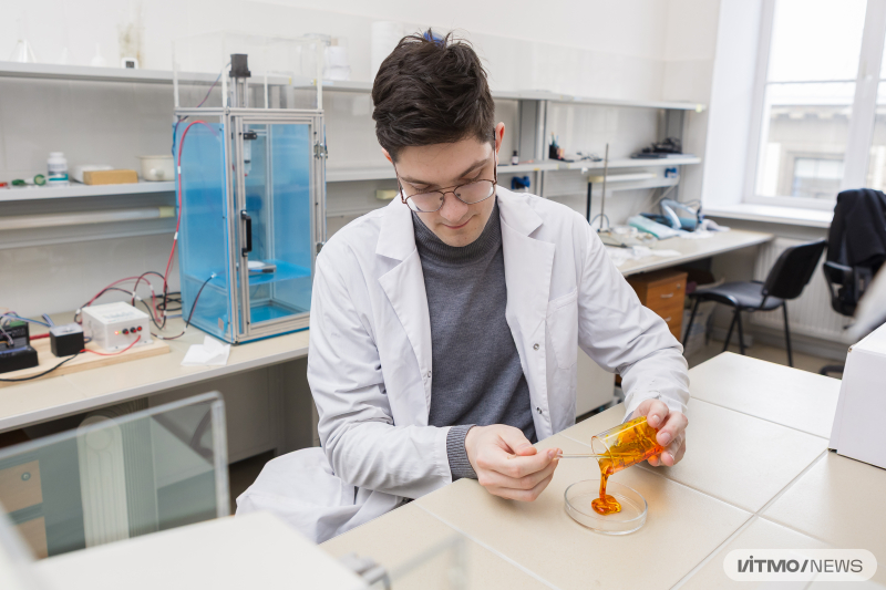 Roman Shaikenov pours a polymer-based solution into a Petri dish. Photo by Dmitry Grigoryev / ITMO NEWS
